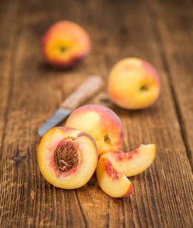 Peaches on a vintage background as detailed close-up shot, selective focus