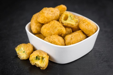 Some Chili Cheese Nuggets on a vintage slate slab (selective focus)