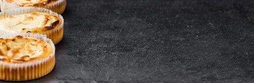 Some fresh Cheesecake on a vintage slate slab (selective focus, close-up shot)