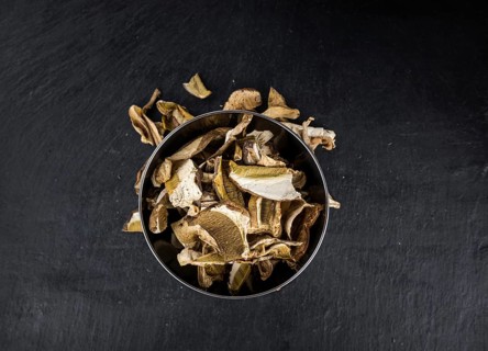 Some Dried Porcinis on a slate slab as detailed close-up shot, selective focus