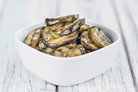 Homemade Antipasti (Grilled Zucchinis) on vintage background (selective focus, close-up shot)