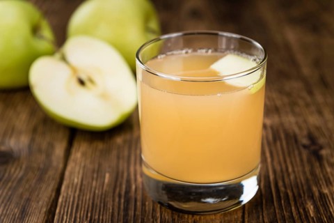 Fresh made Juice (apple) on a vintage background (close-up shot)