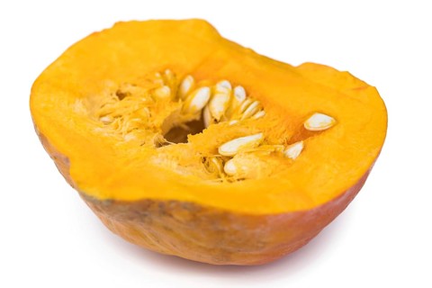 Portion of fesh Pumpkin (close-up shot) isolated on a white background