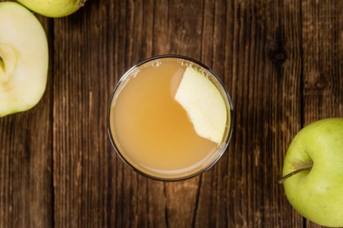 Fresh made Juice (apple) on a vintage background (close-up shot)