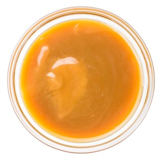 Caramel Sauce on a vintage slate slab (close-up shot, selective focus)
