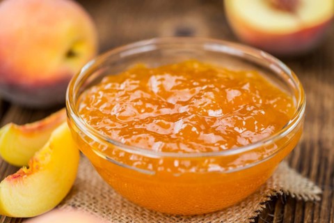 Peach Jam on a vintage background as detailed close-up shot, selective focus