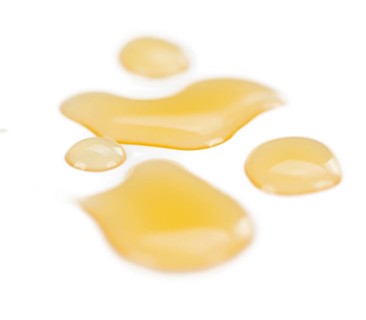 Syrup (Caramel taste) isolated on white background (selective focus, close-up shot)