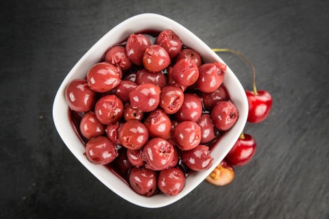 Fresh made Canned Cherries on a vintage background as detailed close-up shot