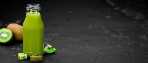 Fresh made Kiwi Smoothie (selective focus) on a vintage looking background