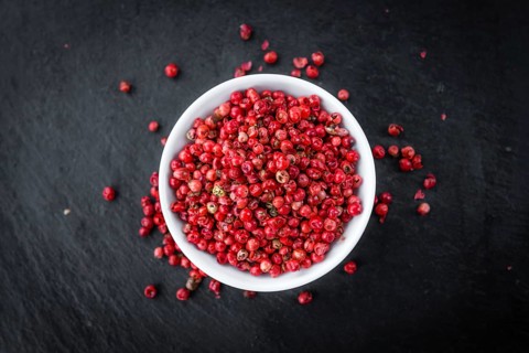 Pink Peppercorns on a vintage background as detailed close-up shot, selective focus