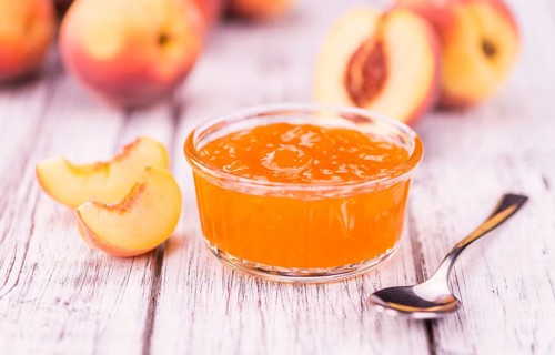 Peach Jam on a vintage background as detailed close-up shot, selective focus