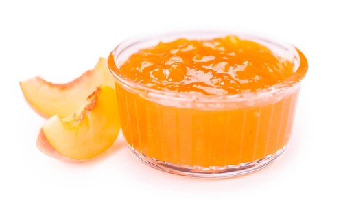 Peach Jam on a vintage slate slab as detailed close-up shot, selective focus