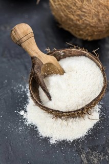 Some fresh made Coconut flour on a vintage slate slab (selective focus)