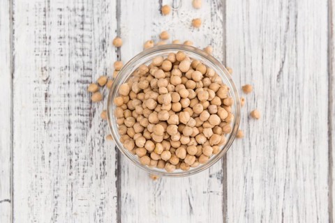 Chickpeas on a vintage background as detailed close-up shot, selective focus