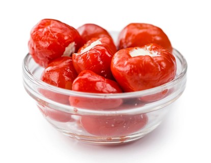Filled Pimientos isolated on white background (selective focus, close-up shot)