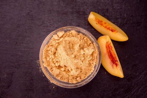 Peach powder on a vintage slate slab as detailed close-up shot, selective focus