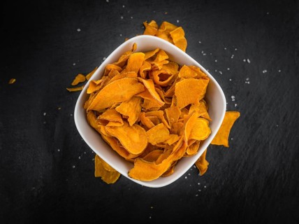 Homemade Sweet Potato Chips on vintage background selective focus, close-up shot