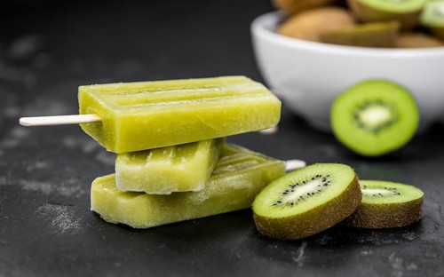 Kiwi Popsicles on a vintage looking slate slab (selective focus)