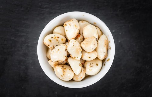 Fresh made Garlic (preserved) on a vintage background (close-up shot)