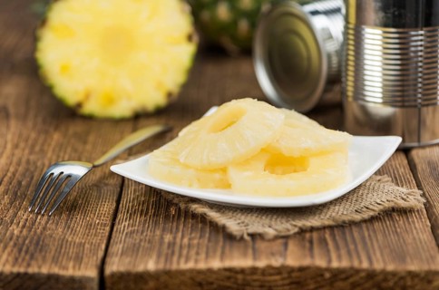 Fresh made Preserved Pineapple Rings on a vintage background as detailed close-up shot