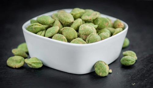 Homemade Peanuts (with Wasabi flavor) on vintage background (selective focus, close-up shot)