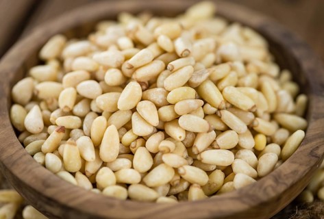 Pine Nuts on a vintage background as detailed close-up shot (selective focus)
