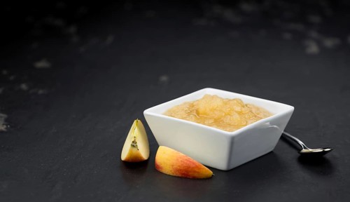 Homemade Applesauce (selective focus, close-up shot) on vintage background with some fresh fruits