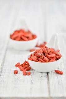 Fresh made Dried Goji Berries on a vintage background (close-up shot)