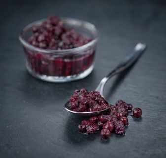 Preserved Blueberries on a vintage background as detailed close-up shot, selective focus