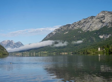 Morning mist drifts over a forest, Grundlsee in the morning light, near Gössl, Salzkammergut,