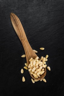 Portion of fresh Pine Nuts (close-up shot, selective focus)