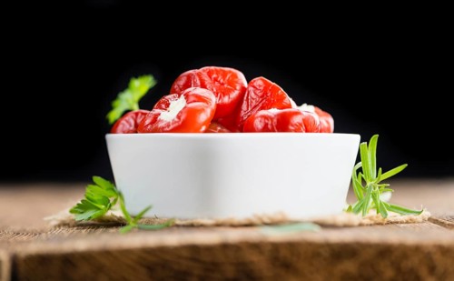 Homemade Filled Pimientos on vintage background (selective focus, close-up shot)