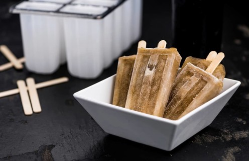 Cola Popsicles (selective focus) on a vintage background as detailed close-up shot