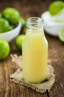 Lime Juice on a vintage background as detailed close-up shot (selective focus)