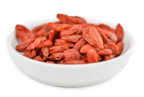 Goji Berries (dried) isolated on white background (selective focus, close-up shot)