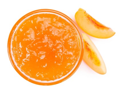 Portion of Peach Jam on a rustic slate slab, selective focus, close-up shot