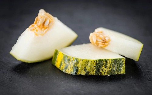 Portion of Futuro Melons as detailed close up shot on a slate slab (selective focus)