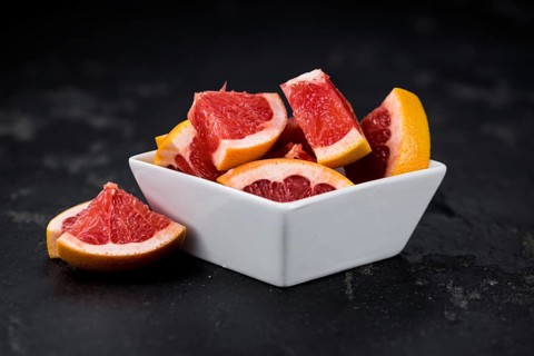 Grapefruits slices (selective focus) on a vintage background as detailed close-up shot
