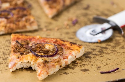 Portion of sliced Pizza (detailed close-up shot, selective focus)