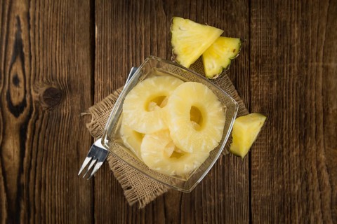Preserved Pineapple Rings on a vintage background as detailed close-up shot, selective focus
