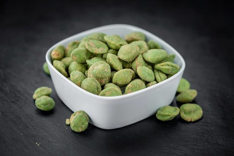 Some fresh Wasabi Peanuts on a vintage slate slab (selective focus, close-up shot)