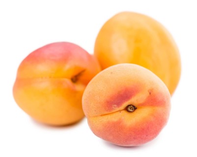 Portion of Apricots (as close-up shot) isolated on white background