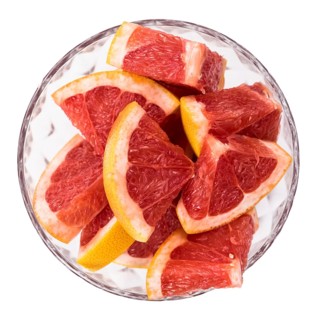 Portion of chopped Grapefruits isolated on white background (close-up shot)