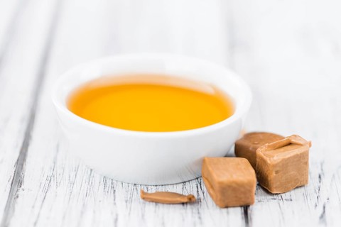Caramel Sirup on a vintage background as detailed close-up shot (selective focus)