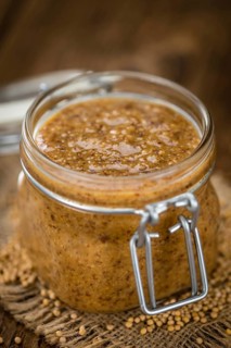 Fresh made German Cuisine (sweet Mustard) on a vintage background (close-up shot)