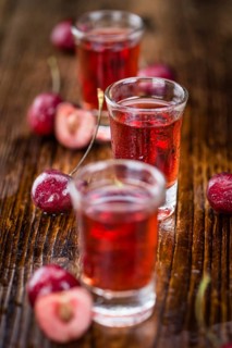 Homemade Cherry Liqueur on vintage background selective focus, close-up shot
