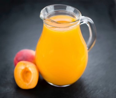 Apricot Juice on a vintage slate slab (close-up shot, selective focus)
