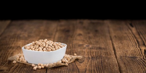 Chickpeas on a vintage background as detailed close-up shot, selective focus