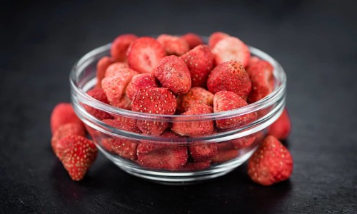 Some fresh Dried Strawberries on a vintage slate slab, selective focus, close-up shot