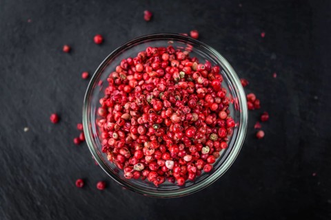 Pink Peppercorns on a vintage background as detailed close-up shot, selective focus
